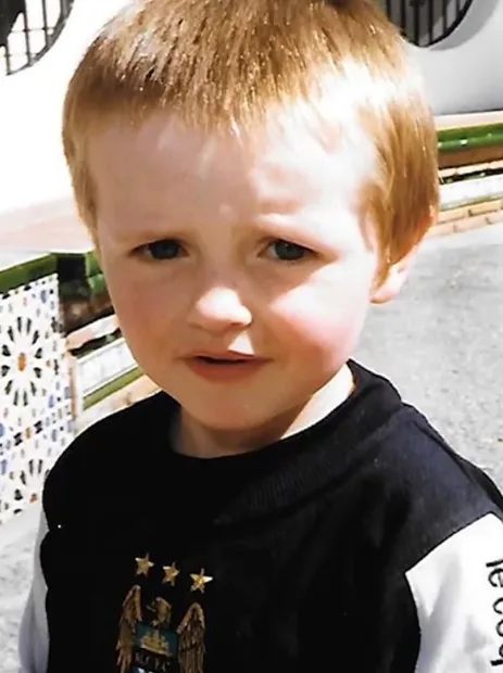 Tom as a small boy in a Manchester City shirt