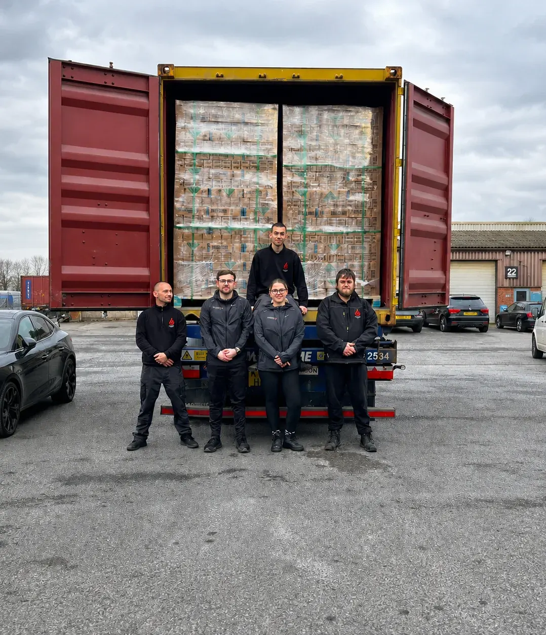 The team in front of the first container of Firestorm stock, Christmas 2024