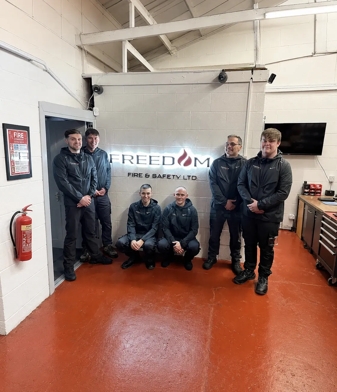 The team in front of the Freedom Fire sign at Unit 10